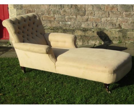 A Victorian upholstered day bed with deep button back, scrolled arms and raised on square tapered legs with cup castors
