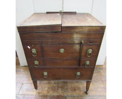 A George III mahogany gentleman's washstand with foldover top, revealing a comprehensively divided interior, over a further p
