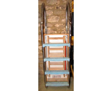 An unused timber loft ladder of folding form within a further timber framework, together with a flight of swimming pool steps