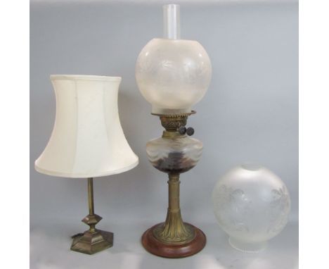 A brass oil lamp with glass font and twin burner, globe and chimney, together with an Edwardian brass table lamp (2)