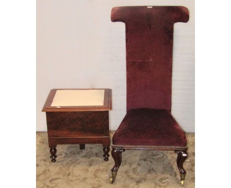 A Victorian Prie Dieu, with tapered velvet upholstered seat and T shaped back, raised on cabriole forelegs with brass caps an