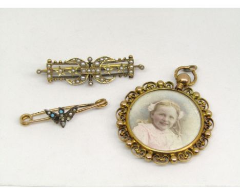 15ct circular picture pendant with scrolled border, together with a yellow metal and seed pearl brooch of crescent and star d