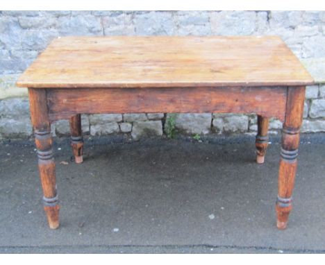 A Victorian pine kitchen table of rectangular form with end frieze drawer, raised on four ring and turned tapered legs, appro