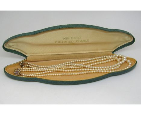 Double strand graduated pearl necklace, the 9ct clasp set with an amethyst and pearl cluster and a further single strand exam