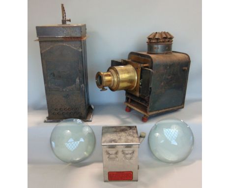 A good quality vintage tin cased magic lantern with brass fittings together with two large convex lenses, and a Dallan develo