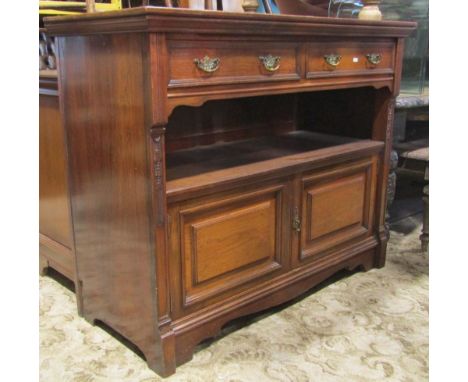 A late Victorian walnut sideboard, fitted with two frieze drawers, over an open fronted compartment and cupboard enclosed by 