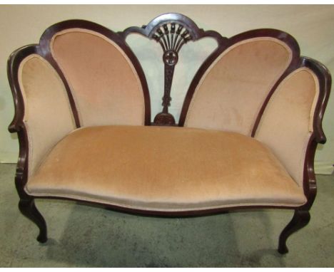 An Edwardian mahogany two seat parlour sofa, with upholstered seat and back pads within a shaped carved and moulded showwood 