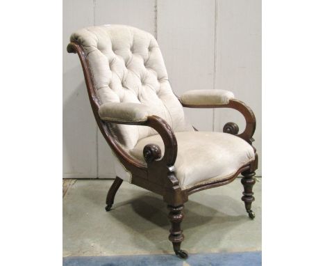 A Victorian drawing room chair with upholstered seat, arm pads and scrolled button back, scrolled arms and turned forelegs