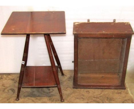 An arts and crafts walnut two tier occasional table, the square cut and moulded top raised on four splayed, turned and tapere