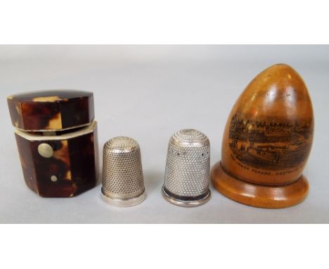 Good 19th century tortoiseshell octagonal thimble case, enclosing a silver thimble, with a further Mauchlineware thimble case