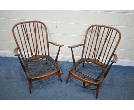 A PAIR OF DARK ERCOL SPINDLE BACK ARMCHAIRS, with open armrests, turned supports, legs and stretchers, width 70cm x depth 80c