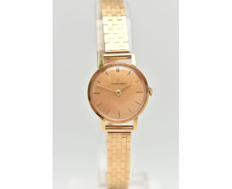 A 9CT GOLD ETERNA MATIC WRISTWATCH, the textured champagne coloured dial, with gold coloured hourly markers and hands, case d