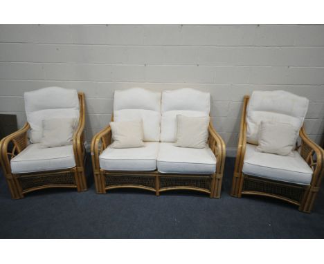 A RATTAN THREE PIECE CONSERVATORY SUITE, comprising a two seater sofa, length 136cm x depth 97cm x height 76cm, along with a 