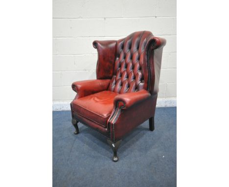 AN OXBLOOD LEATHER CHESTERFIELD WING BACK ARMCHAIR, on front cabriole legs, width 81cm x depth 84cm x height 110cm (condition