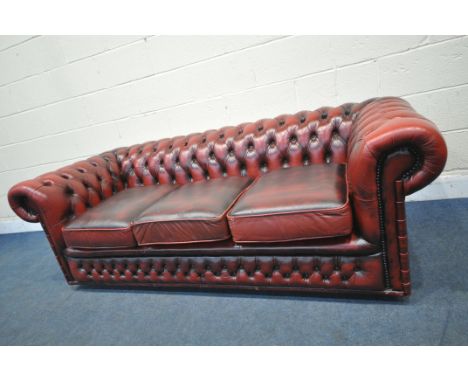 AN OXBLOOD LEATHER CHESTERFIELD BUTTONED THREE SEATER SOFA, length 200cm x depth 90cm x height 68cm (condition report: some c