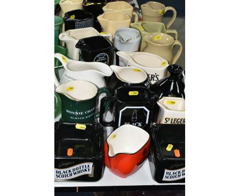 WHISKY ADVERTISING JUGS, comprising a collection of nineteen jugs and two ashtrays, whisky names include Teachers, Queen Anne