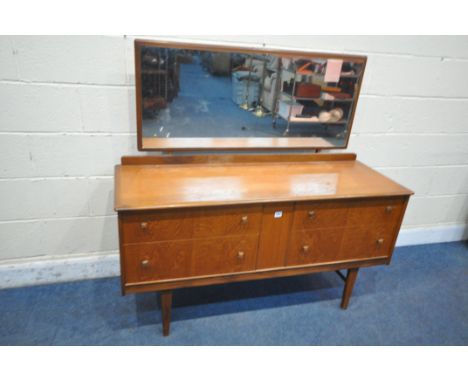 A MID CENTURY TEAK DRESSING TABLE, with a single rectangular mirror, above four drawers, on tapered legs, width 138cm x depth