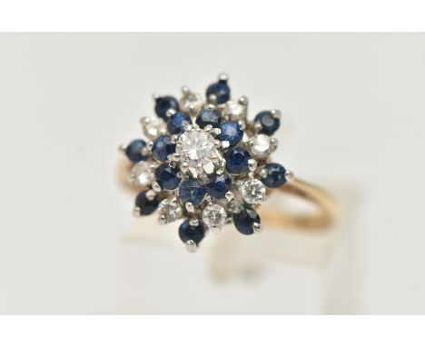 A 9CT SAPPHIRE AND DIAMOND CLUSTER RING, tiered cluster, set with a central round brilliant cut diamond, in a surround of cir