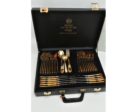 A 'SOLINGEN' BRIEFCASE CANTEEN, 23-24 carat gold-plated cutlery, twelve person table setting, with extra serving utensils, en