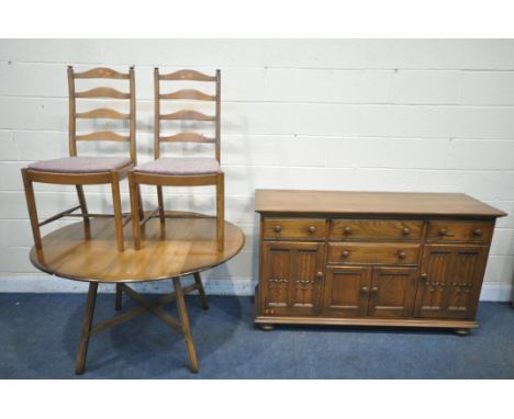 AN ERCOL ELM AND BEECH CANTERBURY SIDEBOARD, fitted with an arrangement of four drawers and doors, on bun feet, width 155cm x