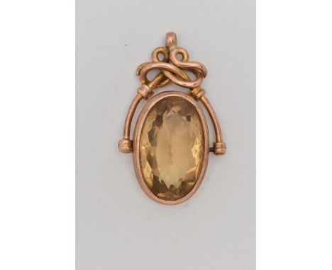 A ROSE METAL CITRINE SWIVEL FOB, large oval cut citrine, collet set in a rose metal mount, stamped AW 9C, fitted with a scrol