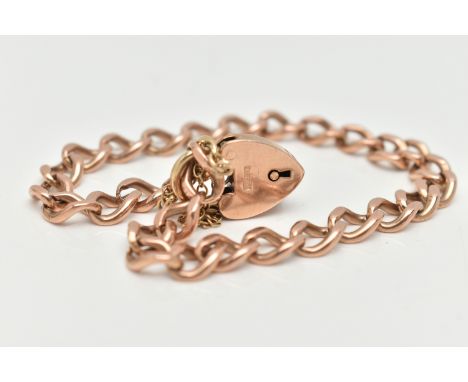 A ROSE METAL CURB LINK BRACELET, solid curb links, most stamped 9.375, fitted with a yellow metal heart padlock clasp stamped