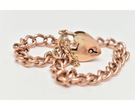 A ROSE METAL CURB LINK BRACELET, solid curb links, most stamped 9.375, fitted with a yellow metal heart padlock clasp stamped