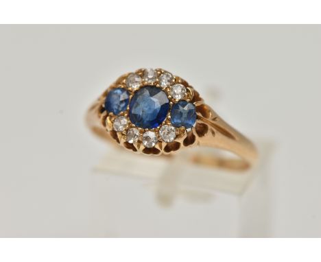 A LATE 19TH CENTURY DIAMOND AND SAPPHIRE RING, three oval mixed cut sapphires, prong set with a surround of eight old cut dia