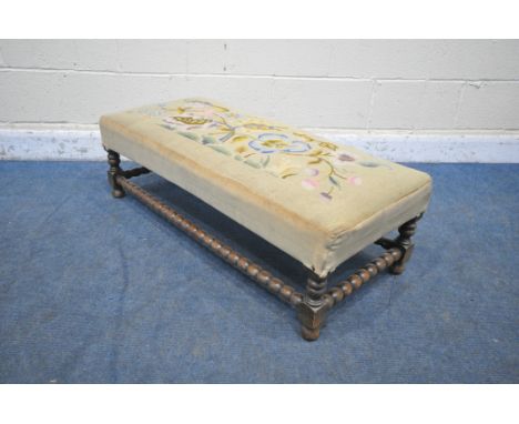 A 20TH CENTURY OAK BOBBIN TURNED STOOL, with needlework upholstery, depicting a squirrel amongst flowers, length 105cm x dept