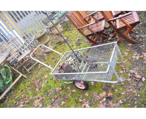A GALVANISED STEEL GARDEN TROLLEY (basket length 100cm) a wrought iron plant stand, a vintage rain hopper and an Avery weight