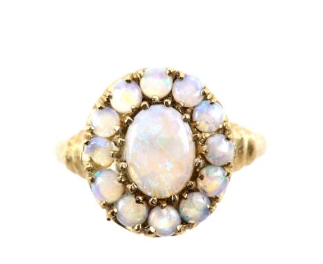 Modern opal cluster ring set in 9 ct gold mount, ring size N 1/2 .      CONDITION9 ct gross weight 2.9 gramsone round cabocho