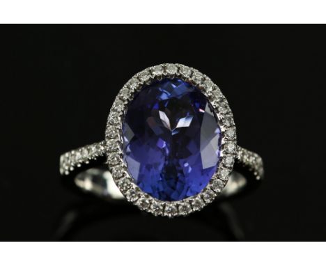 Tanzanite and diamond dress ring, oval cut tanzanite, of good colour, estimated total weight 5.00 carats, set in round brilli