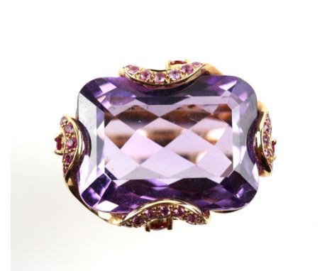An amethyst ring in ornate gem set mount with pink red and orange sapphires and diamonds, the amethyst estimated at 13 carats
