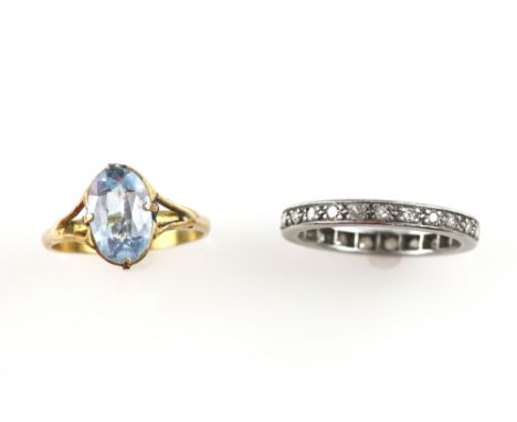 Diamond eternity ring, set with small brilliant cut stones in platinum, ring size N, and a ring set with blue synthetic spine