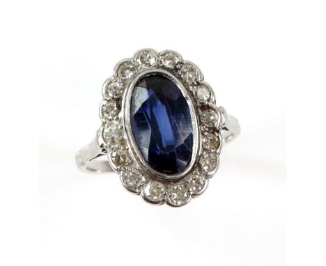 Synthetic sapphire cluster ring, with Swiss cut diamond border, mount testing as platinum, ring size L.      CONDITIONplatinu