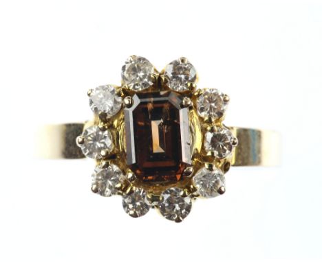 Cognac fancy coloured diamond dress ring,  the central emerald cut stone within a border of white diamonds, fancy diamond wei