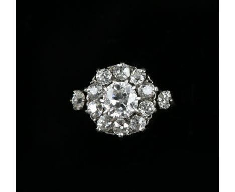 Antique diamond set ring, central old cut stone  estimated weight 1.07 carats, surrounded by twelve other diamonds, estimated