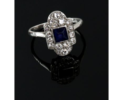 Art Deco panel ring, centrally set with square cut sapphire, surrounded by transitional cut diamond, estimated total diamond 