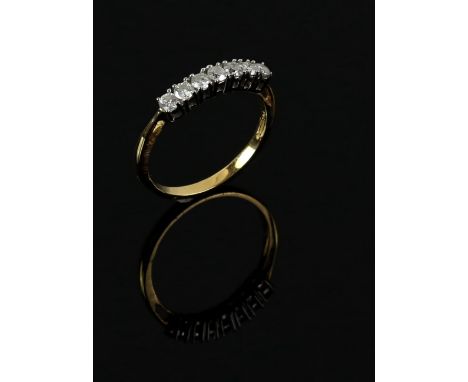 Modern diamond ring, set with seven round brilliant cut diamonds, estimated total diamond weight 0.50 carat, mounted in 18 ct