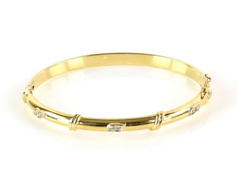 Vintage oval hinged bangle, set with six round brilliant cut diamonds and twisting band detailing, concealed clasp and figure