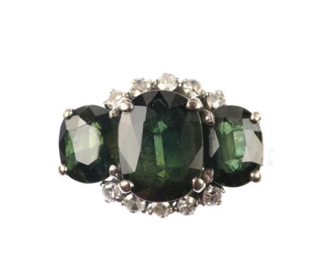 An unusual vintage ring set with green sapphire and diamonds, the centre stone of 2.25 carats, set in 14 ct white gold, ring 