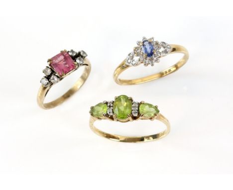 Three rings, sapphire and diamond cluster, ring size U, peridot and white sapphire three stone, size V, both mounted in 9 ct 