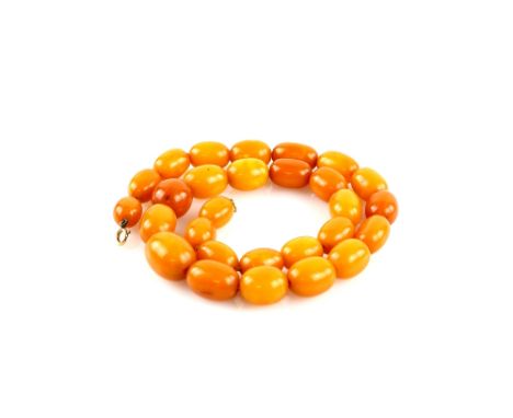 1920's amber graduated bead necklace, largest oval bead, 21 x 16mm, strung without knots, bolt ring clasp, 51cm, with nine lo