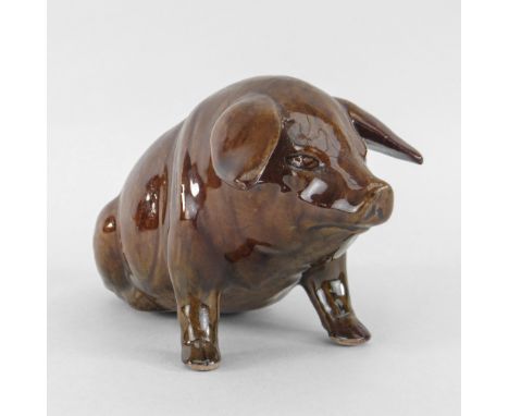 EWENNY POTTERY MODEL OF A SEATED PIG in brown mottled glaze, incised decoration, inscribed to base 'Ewenny Pottery 1900' to b