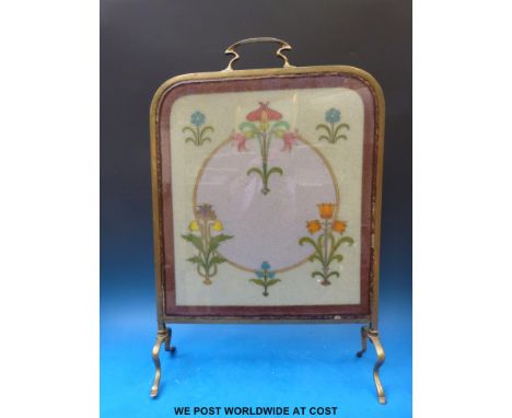 An Art Nouveau glass and brass fire screen