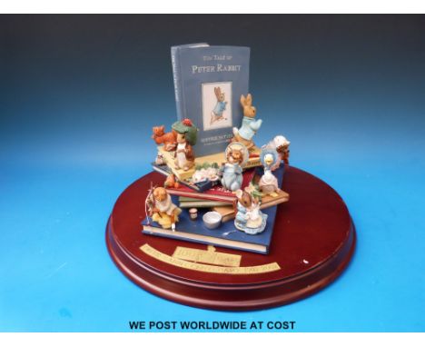 A limited edition ceramic Peter Rabbit centenary book with figures, number 537/4950 with box
