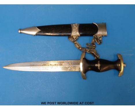 German Nazi Third Reich SS dagger with black painted wooden handle inset with an eagle carrying a swastika in wreath and SS b