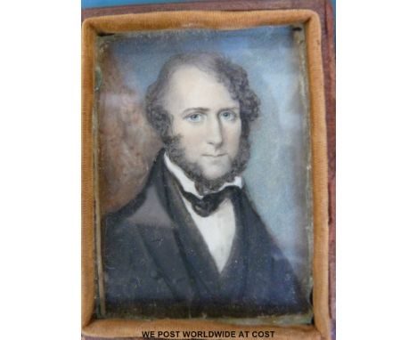 A 19thC portrait miniature of a gentleman wearing a black coat and waistcoat, in folding leather case (7.4 x 5.6cm)