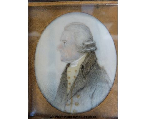 A Georgian oval portrait miniature of a gentleman wearing a dark coat and waistcoat, in later ornate bakelite folding frame (