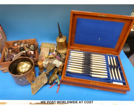 A collection of items to include a canteen of cutlery in a mahogany case, candlesticks, copper jardiniere, brass items includ